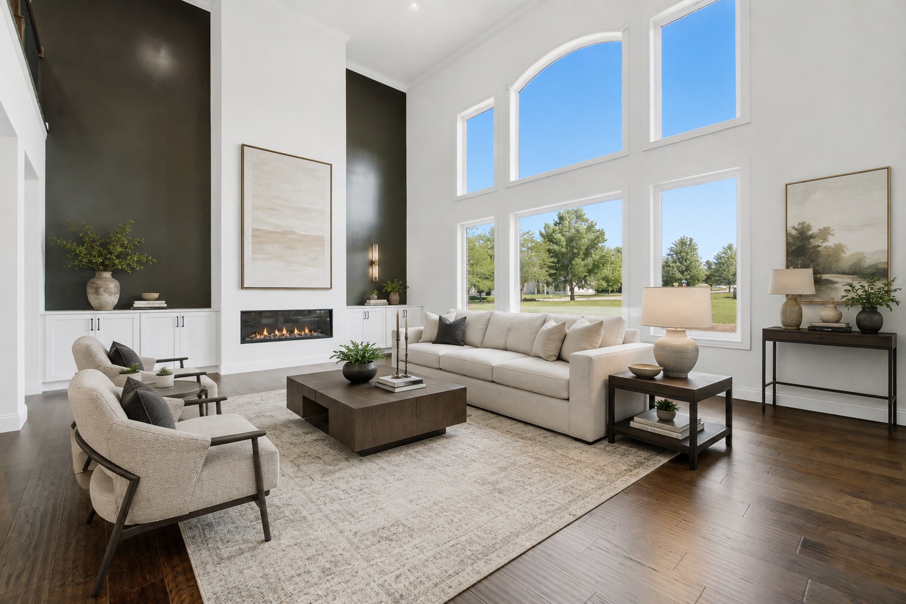The same living room virtually staged with a sofa, rug, coffee table and artwork